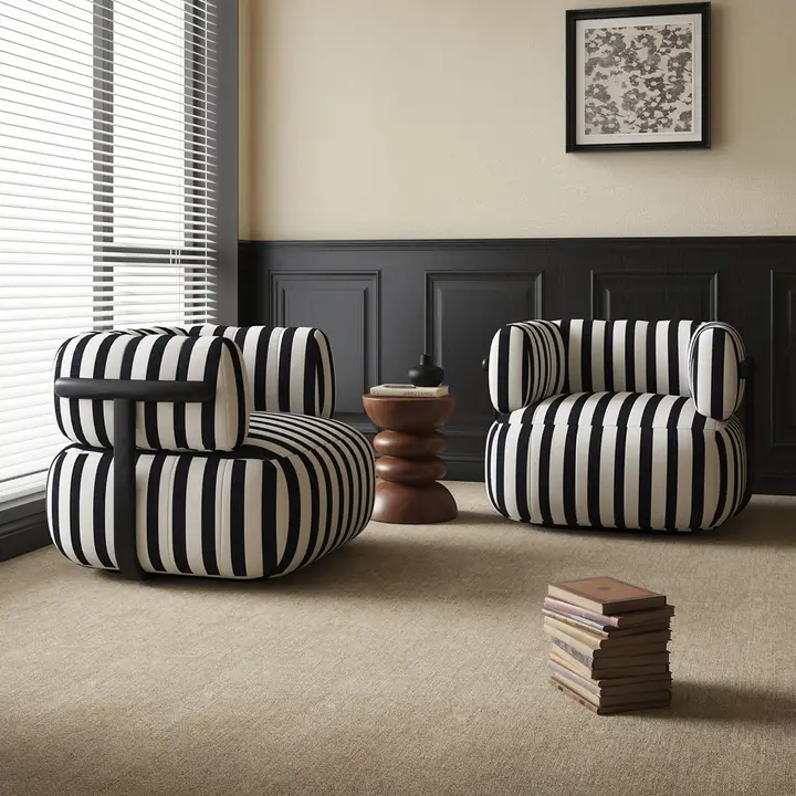 Pair of black-and-white striped barrel lounge chairs with black frames
